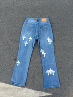 Light blue denim jeans with white cross patches on back, straight leg.