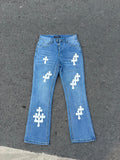 Light blue denim jeans with white cross patches, straight leg.