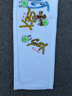 Light blue pants with centered colorful graffiti-style print and small leopard designs