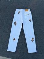 Light blue straight pants with dark cross patches on front legs and back yoke