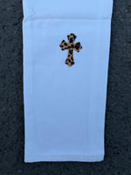 Light blue pants with small leopard-spotted cross graphic on front