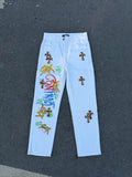 Light blue straight pants with dark cross patches, button fly and belt loops