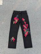 Black denim pants with colorful cross patches and elastic drawstring waistband.