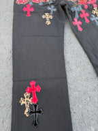 Black pants with red cross patches and small leopard print cross applique