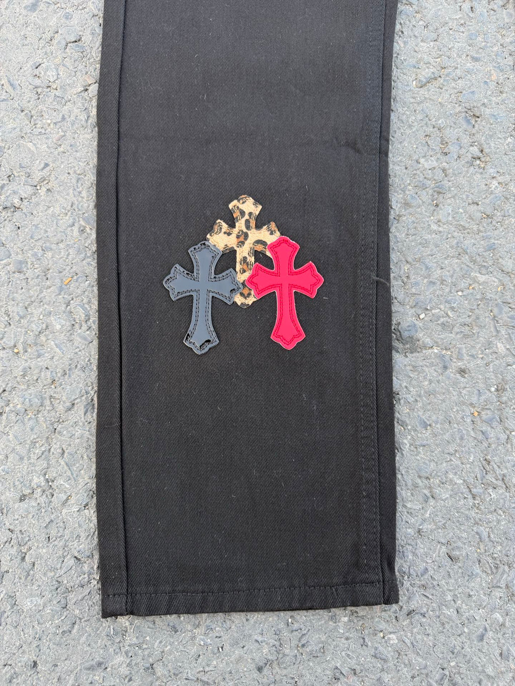 Black pants panel with leopard print and red cross applique