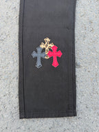 Black pants panel with leopard print and red cross applique