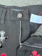 Dark gray denim pants with button closure and exposed zip fly detail near the pocket.