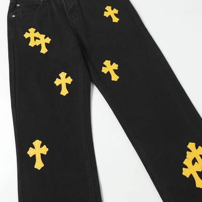 Black pants with yellow cross patches on the front and side