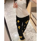 Black pants with gold cross pattern, slim fit