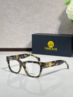 Versace eyeglasses with tortoise-pattern frame and gold Medusa emblem on the temple, clear lenses