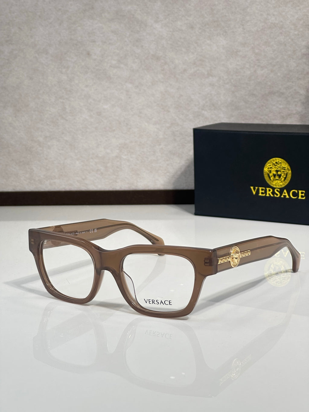 Versace eyeglasses with brown frame and gold Medusa emblem on the temple, clear lenses