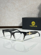 Versace eyeglasses with dark frame and gold Medusa emblem on the temple, clear lenses