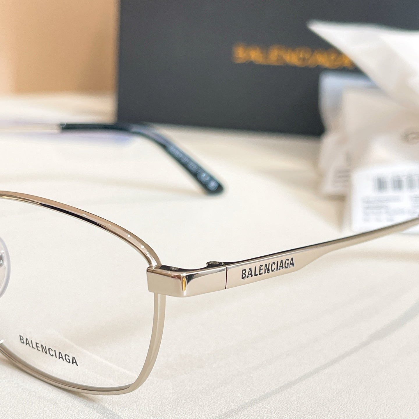 Balenciaga glasses side view with gold frame and dark blue temple with BALENCIAGA