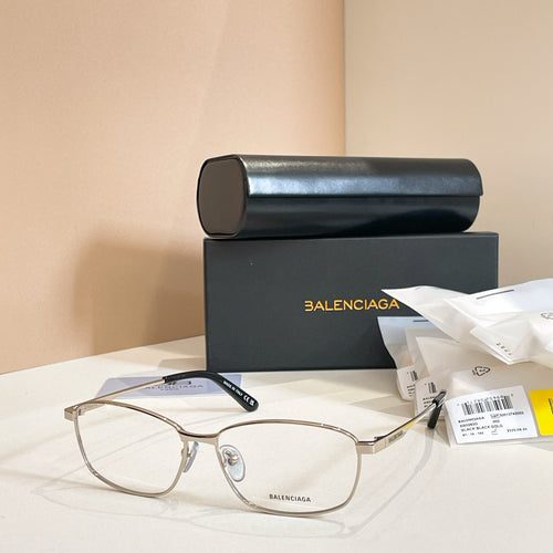 Balenciaga glasses with gold full-rim frames, clear lenses, and dark blue temples