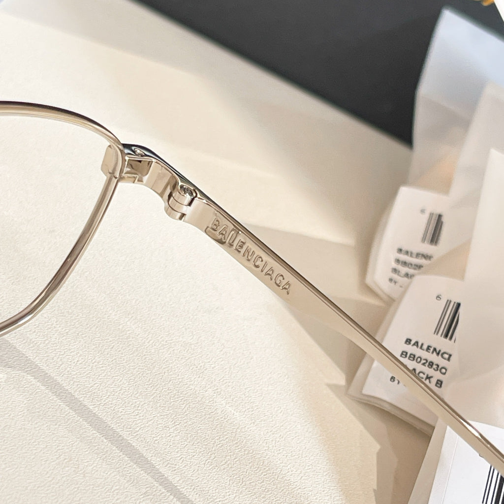 Balenciaga glasses close-up: clear lenses and metal temple engraved BALENCIAGA