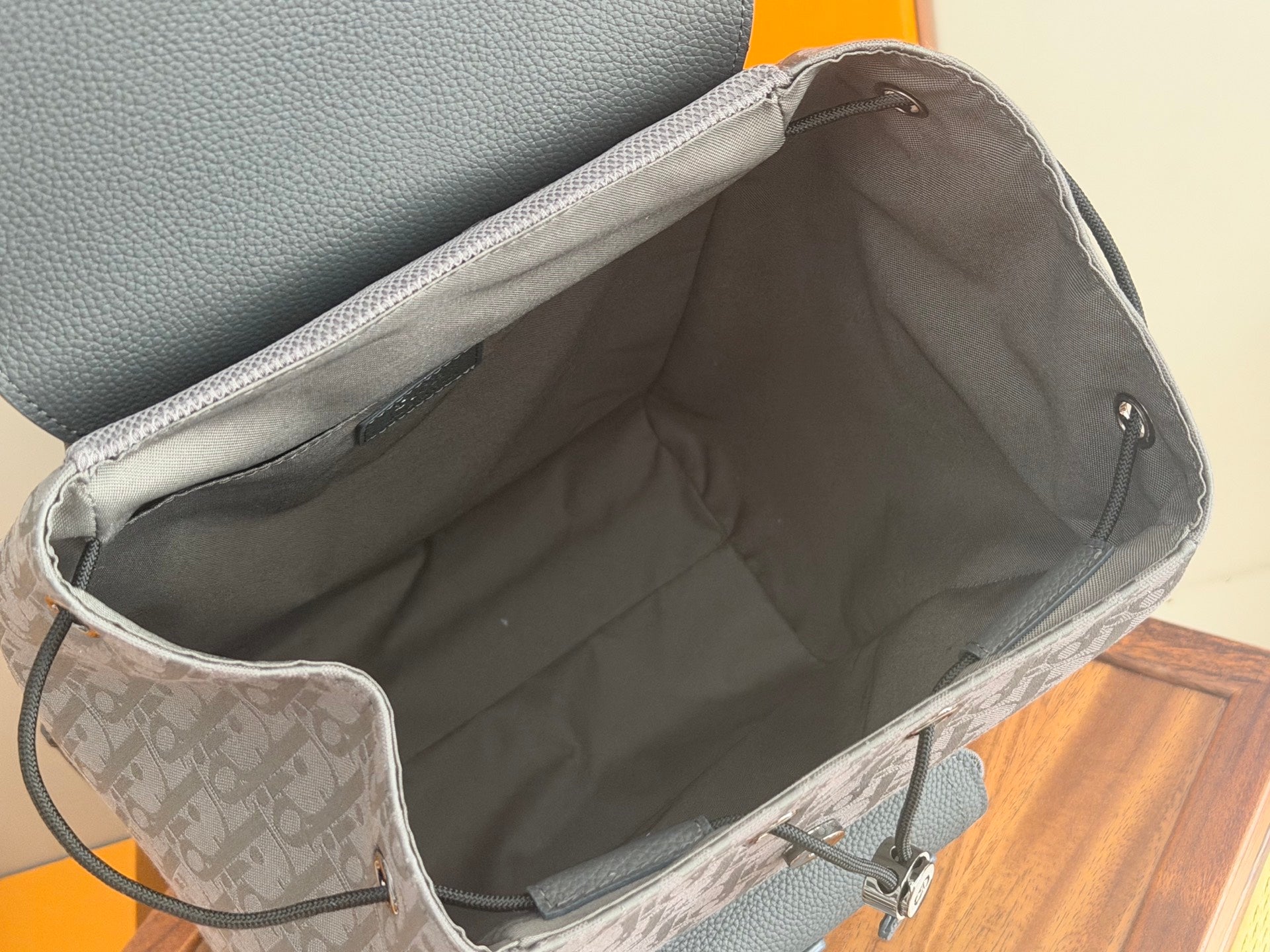 Dior gray monogram backpack interior with open top and drawstring cord
