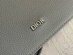 Dior men’s backpack close-up of dark gray leather with DIOR embossed logo