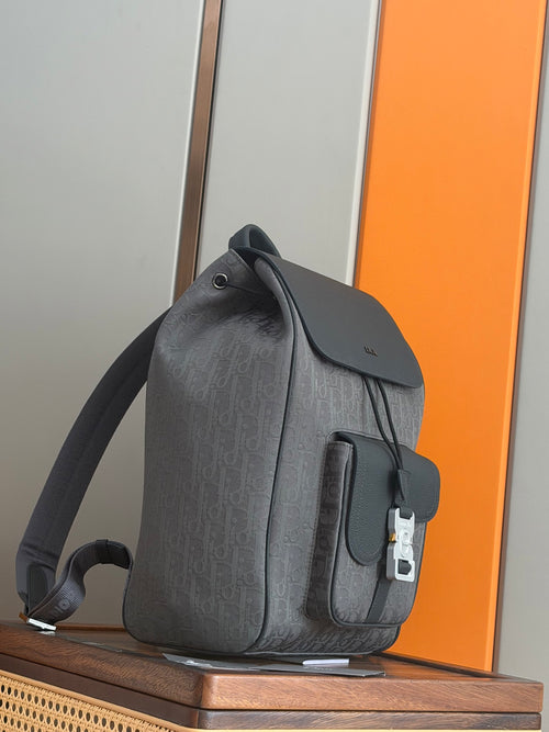 Dior men’s backpack in dark gray with front pocket flap and silver tone clasp hardware