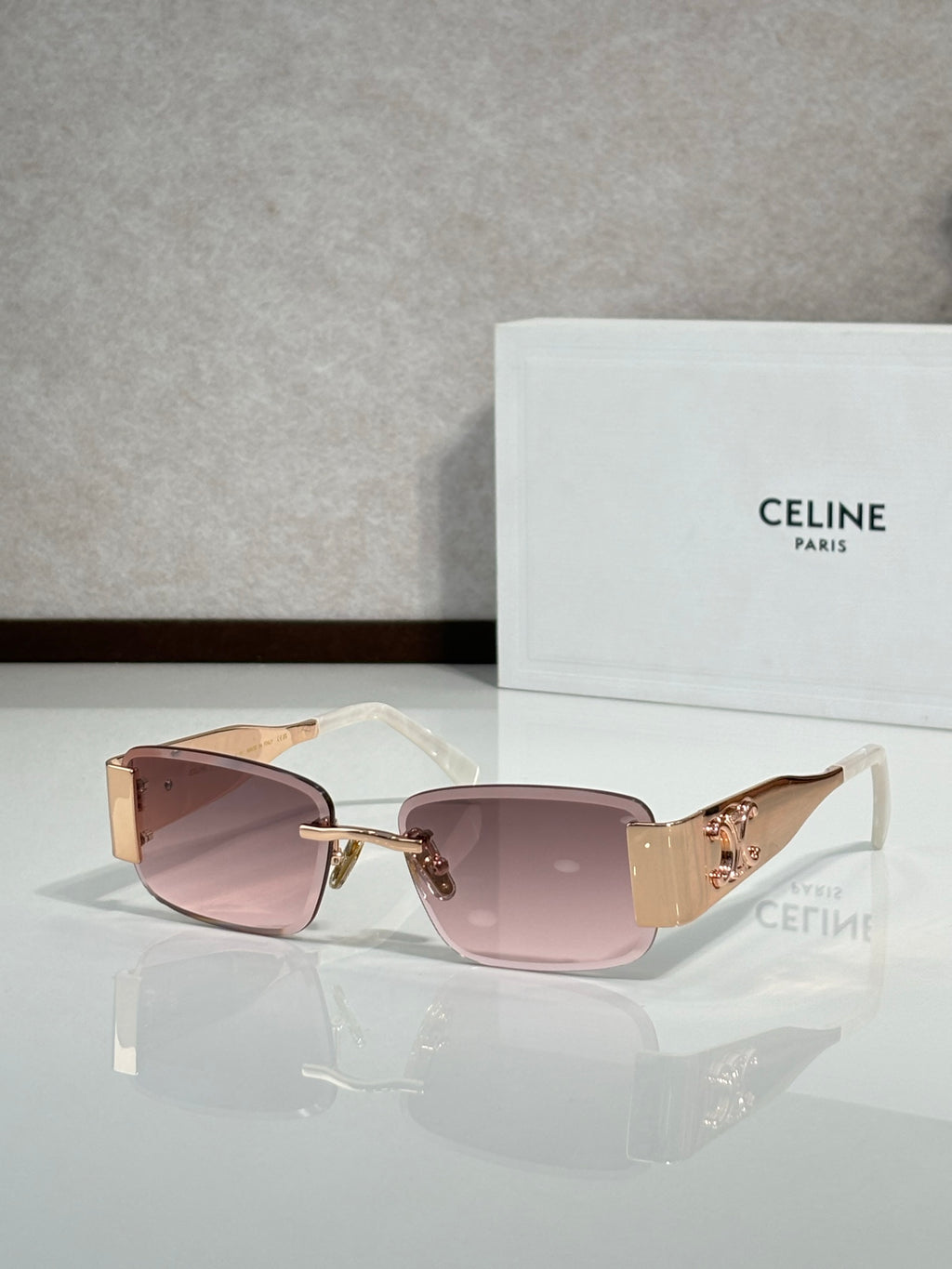 Rose-gold rectangular sunglasses with mauve gradient lenses