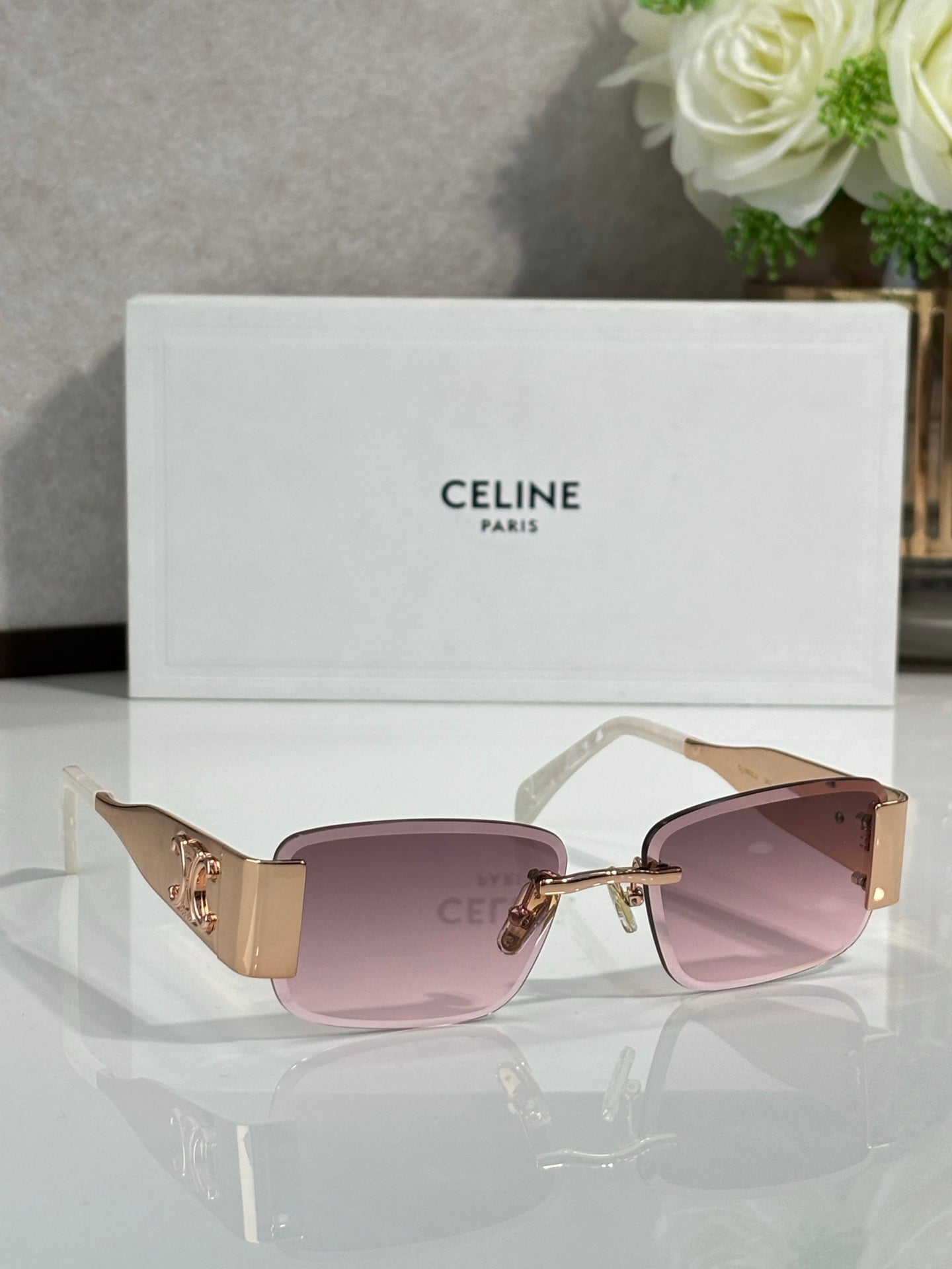 Gold rectangular sunglasses with light purple gradient lenses