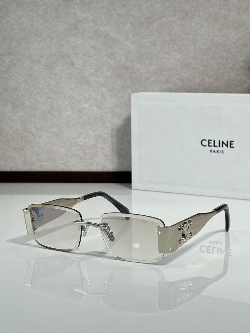 Clear and silver rectangular sunglasses with dark gray gradient lenses