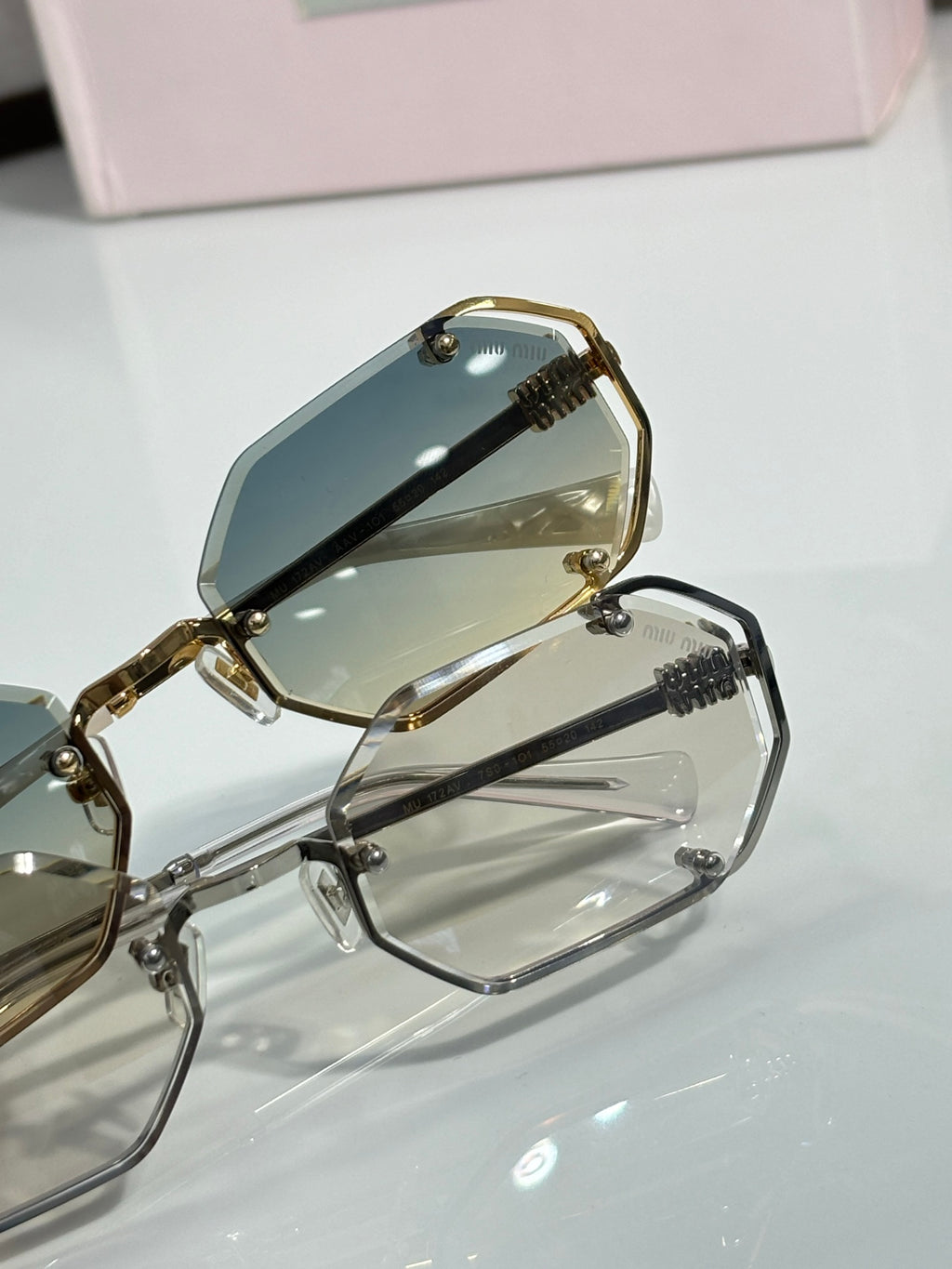 Miu Miu octagonal sunglasses close-up, gold hinge with tinted lens