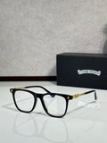 Black full-rim eyeglasses with clear lenses and gold detail temples
