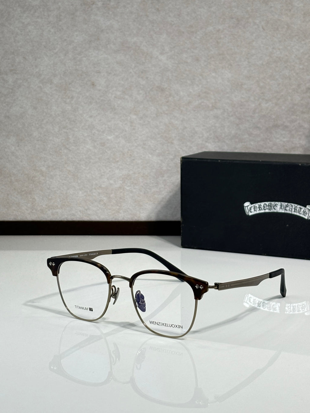 Eyeglasses with dark metal frame and clear lenses, curved temple arms