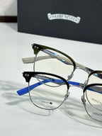 Two pairs of eyeglasses with clear lenses, blue and green temple frames