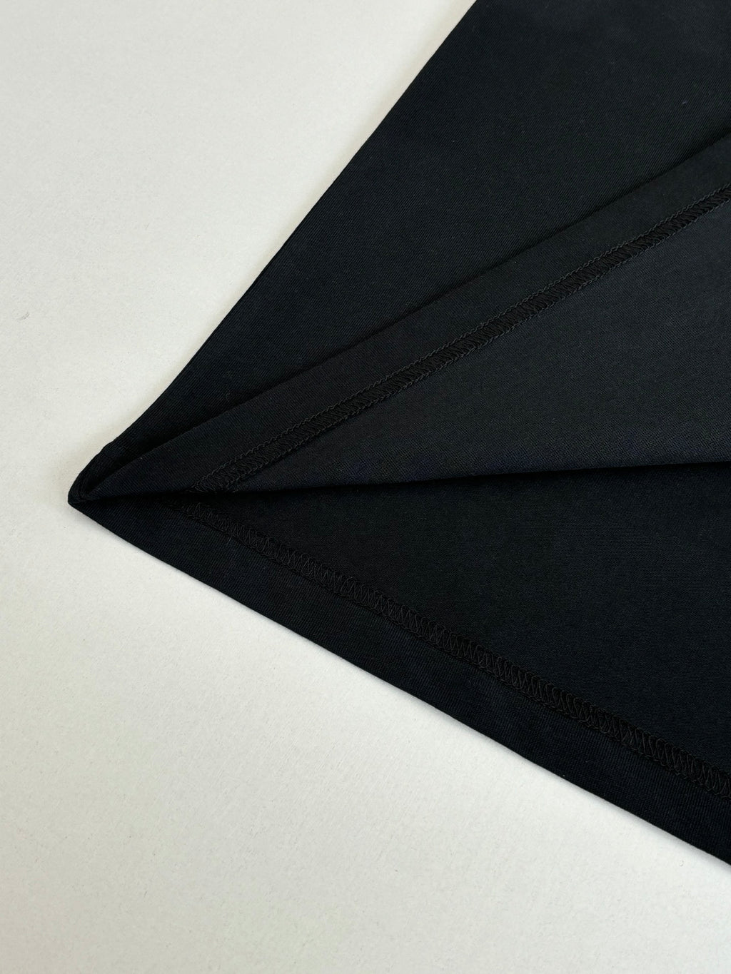 Black short-sleeve T-shirt hem and side seam detail