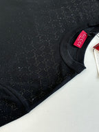 Black short-sleeve T-shirt sleeve close-up with Gucci neck tag