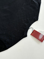 Black short-sleeve T-shirt torso with red Gucci tag on a white surface