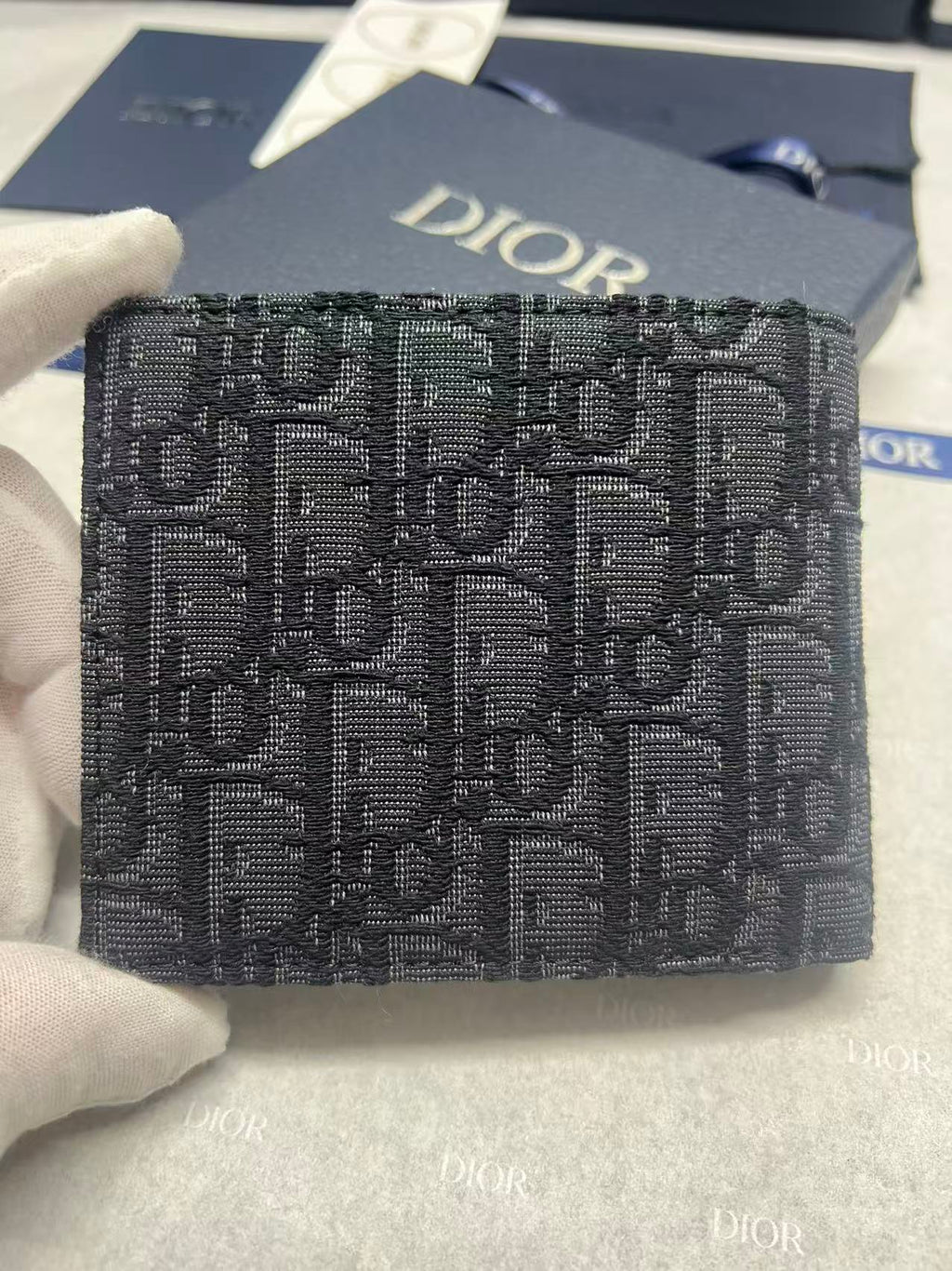 Small bag with Dior monogram fabric, navy, front view with Dior logo.