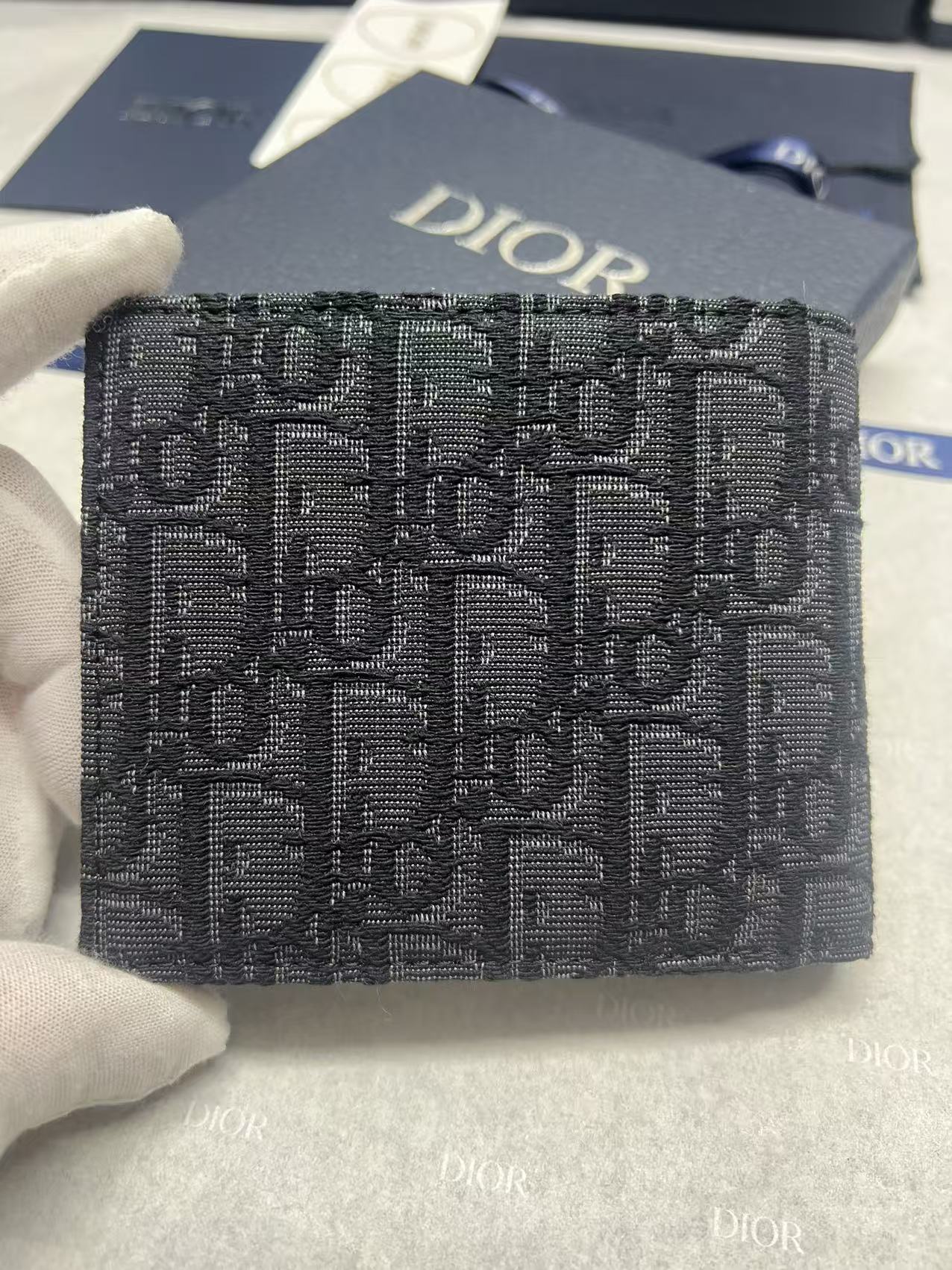 Small bag with Dior monogram fabric, navy, front view with Dior logo.