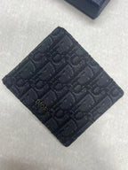 Small bag with Dior monogram fabric, navy, square folded front view.