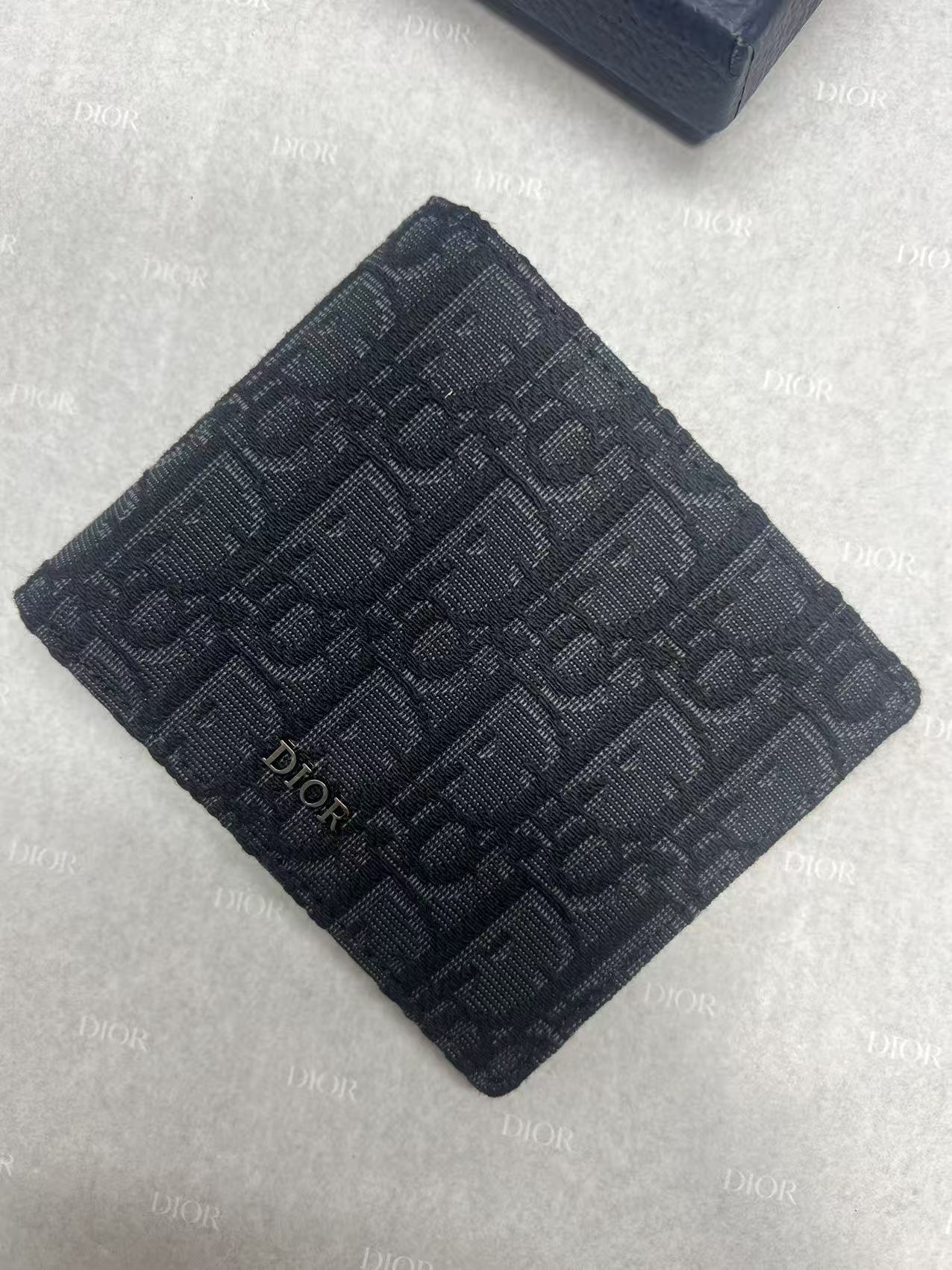 Small bag with Dior monogram fabric, navy, square folded front view.