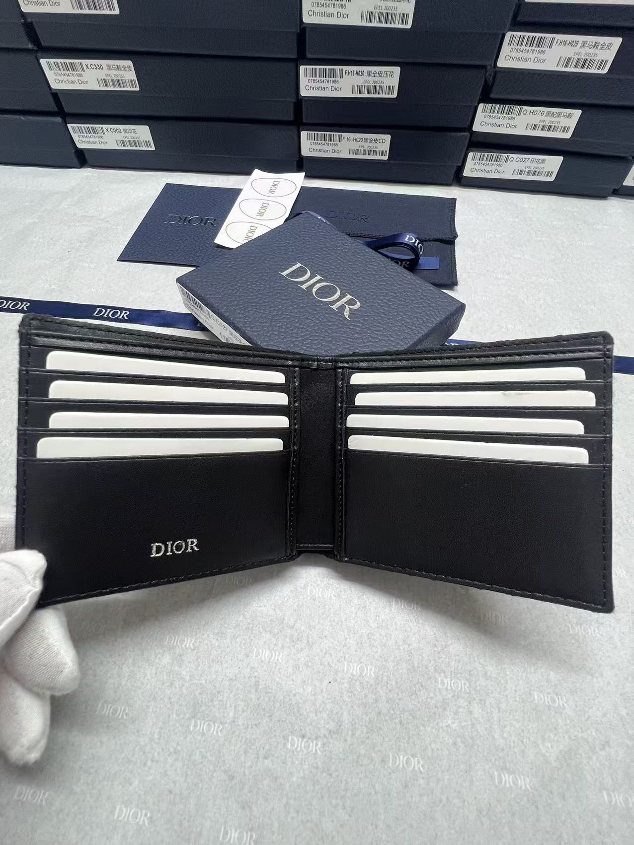 Small bag wallet with Dior logo, bi-fold design and card slots.