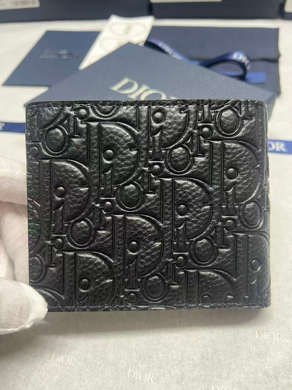 Small leather card holder with Dior monogram embossed texture, black front view.