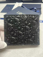 Small leather card holder with Dior monogram embossed texture, black front view.