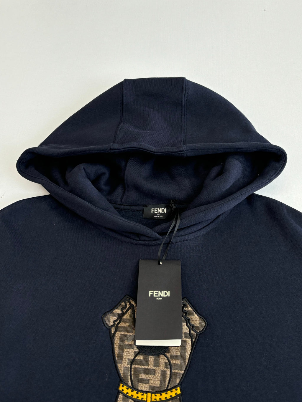 Navy Fendi hoodie with bear graphic and FENDI tag near neckline
