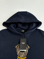 Navy Fendi hoodie with bear graphic and FENDI tag near neckline
