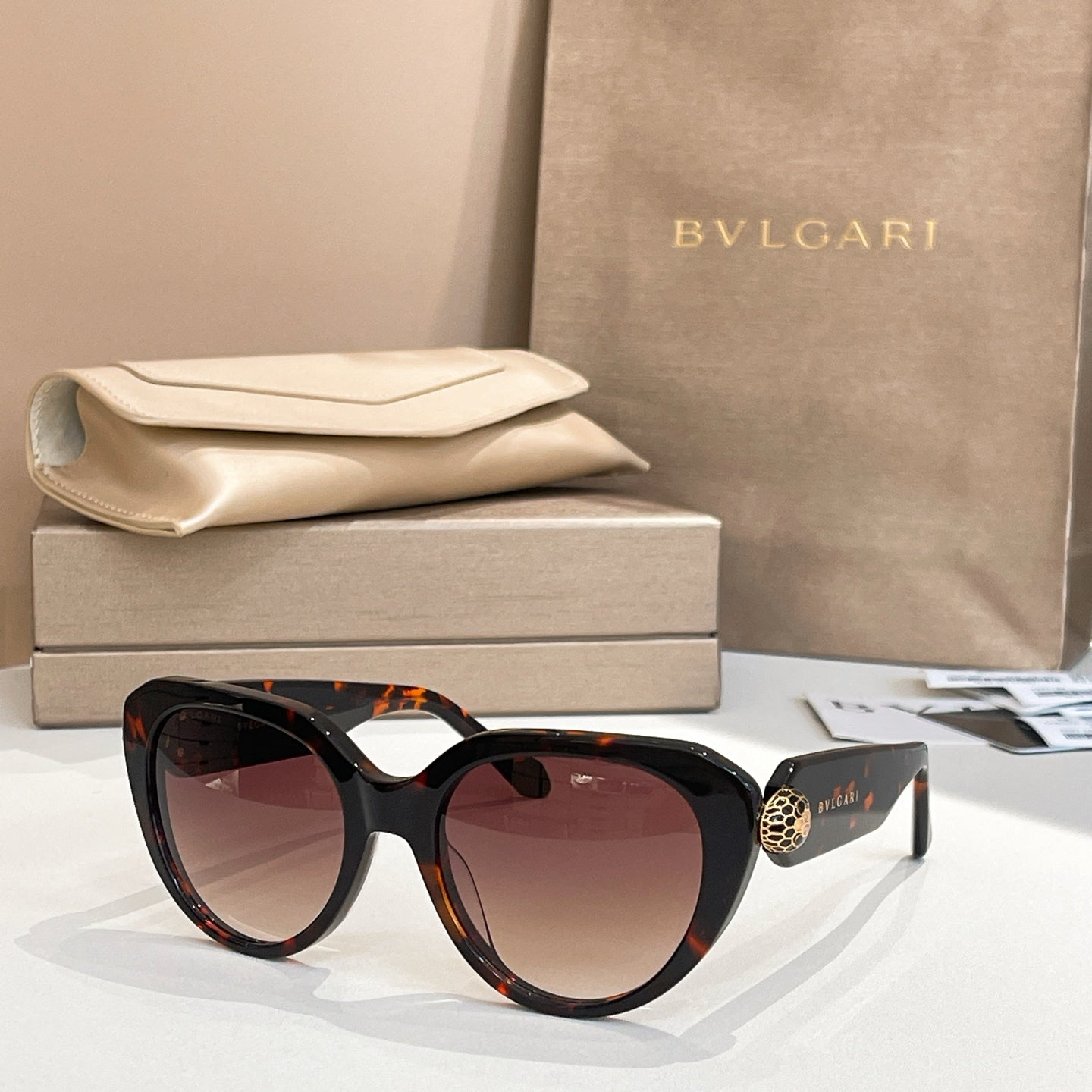 Bvlgari sunglasses with dark tortoiseshell frames and tinted lenses, cat-eye shape