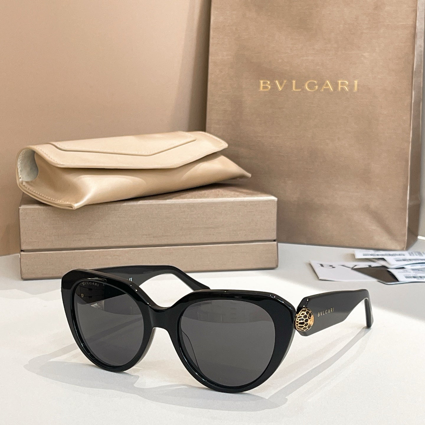 Bvlgari sunglasses with black frames and dark lenses, rounded cat-eye shape