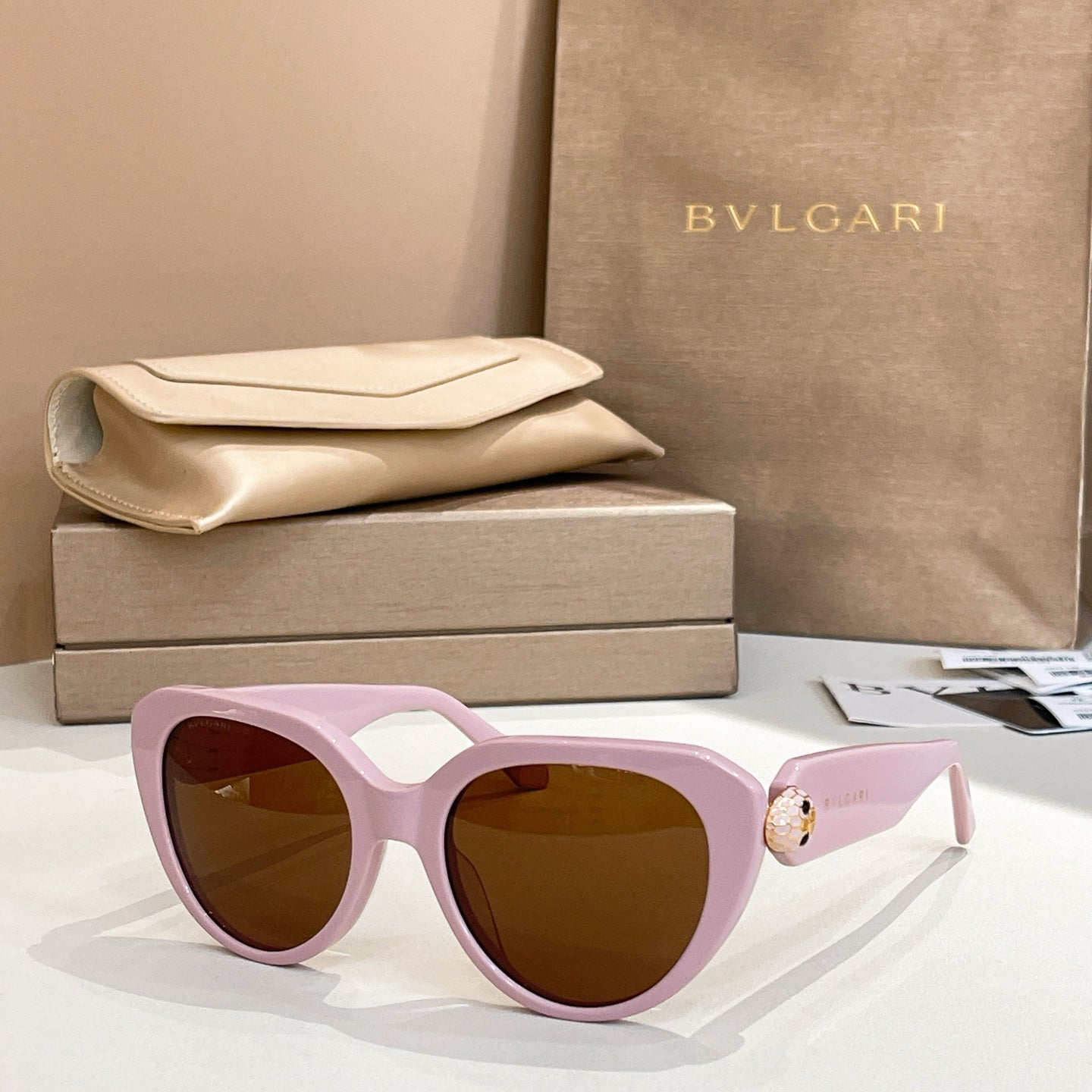 Bvlgari sunglasses with light purple frames and brown lenses, cat-eye shape