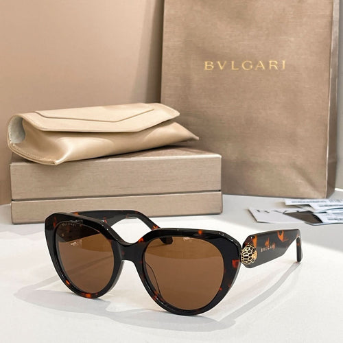 Tortoiseshell round eyeglasses with thick frame and gold logo emblem on temple.