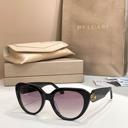 Black round eyeglasses with thick frame, gold logo detail on temple.