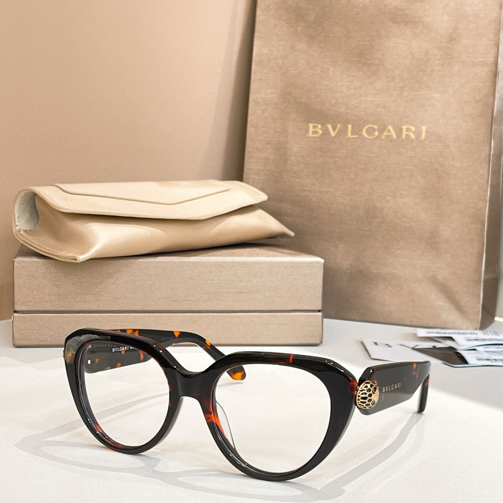 Black round eyeglasses with thick frame and gold logo emblem at temple.