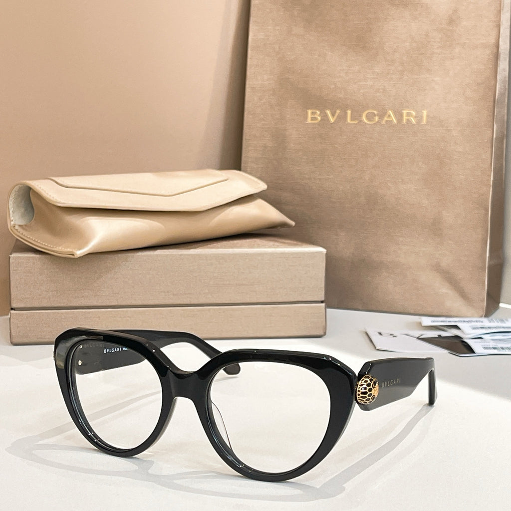 Black round eyeglasses with thick frame and gold emblem on side.