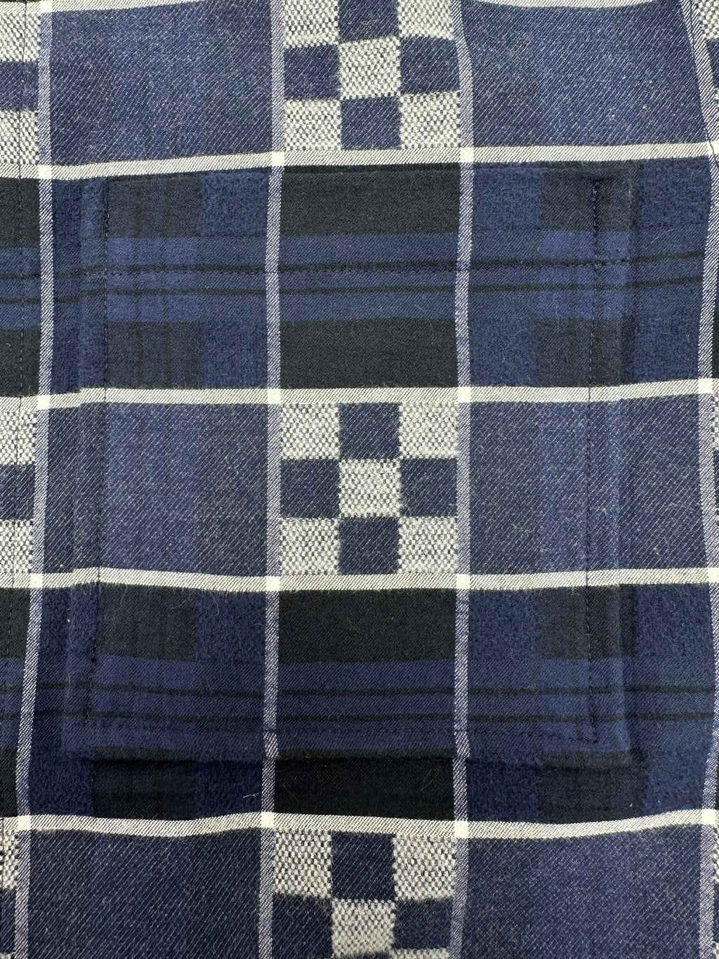 Louis Vuitton plaid fabric close-up with dark navy, white, and blue grid checks
