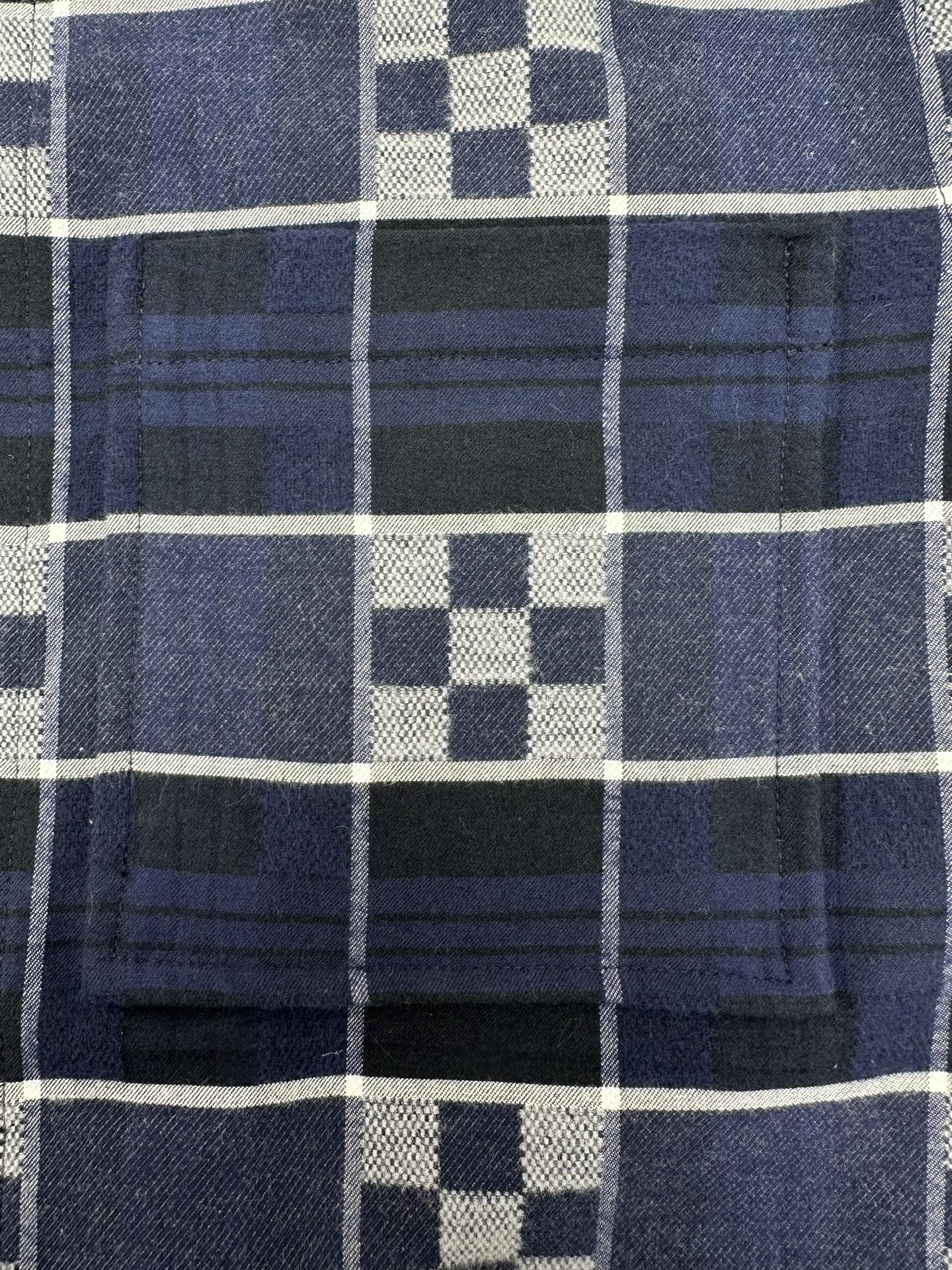 Louis Vuitton plaid fabric close-up with dark navy, white, and blue grid checks